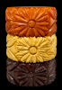 wide daisy carved bakelite bangles